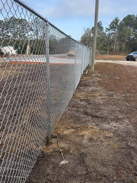 6 foot galvanized chain link fence along a commercial lot